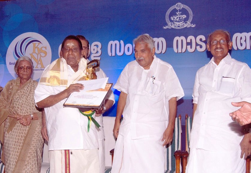Prof.M. Subramonia Sarma receiving 'KALARATHNA' award by Kerala Sangeetha Nataka Academy from Chief Minister of Kerala